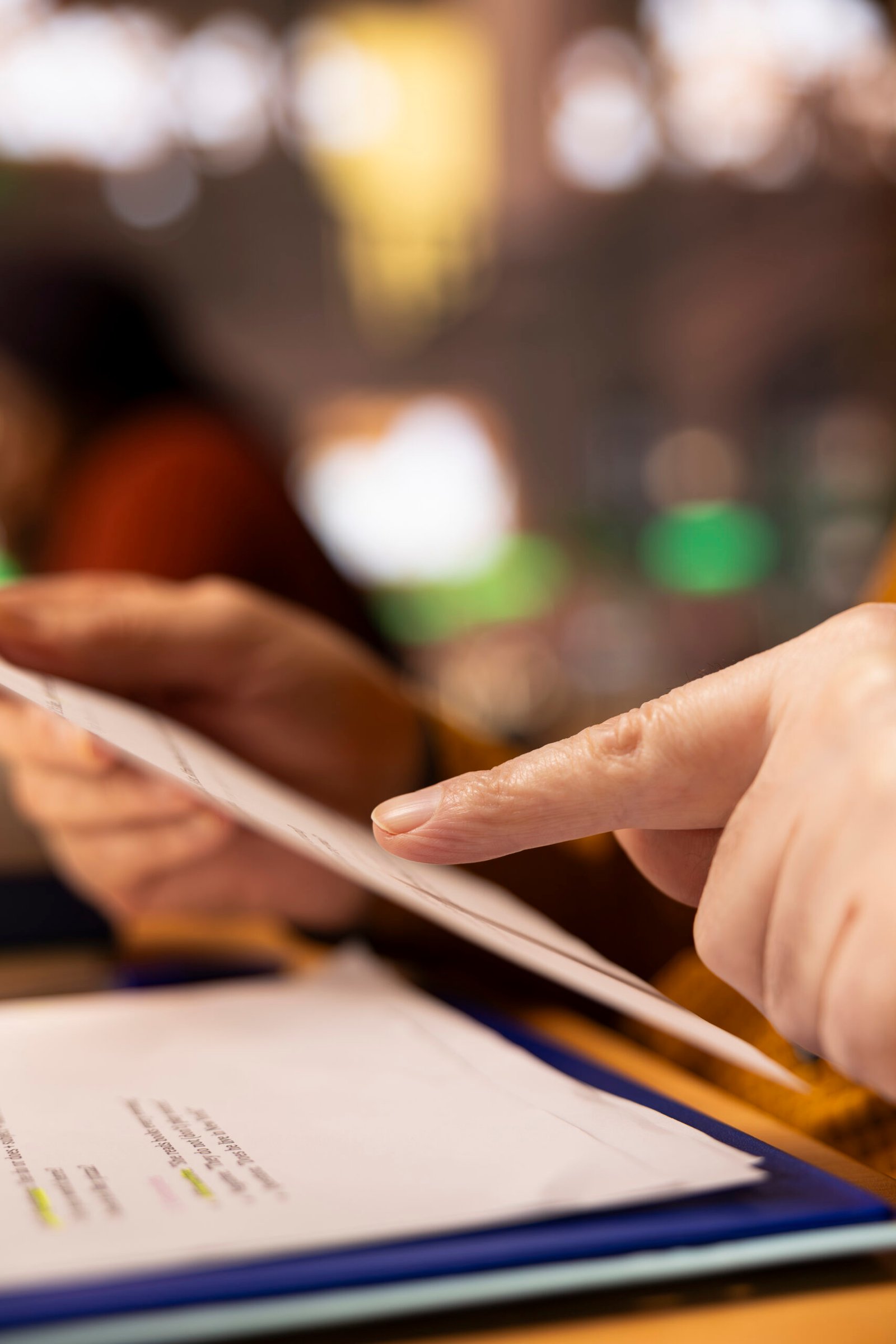 Aged student with a focused expression reading files at college library, academic research and reading textbooks to complete his degree and enrich his understanding of literature. Close up.